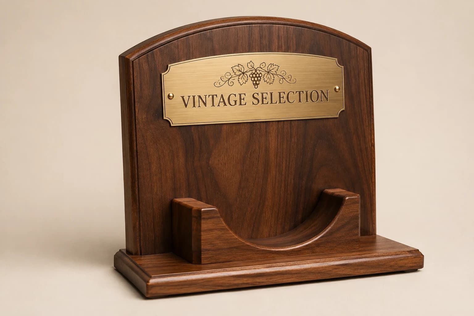 Walnut bottle display plaque with an empty cradle and brass title plate.