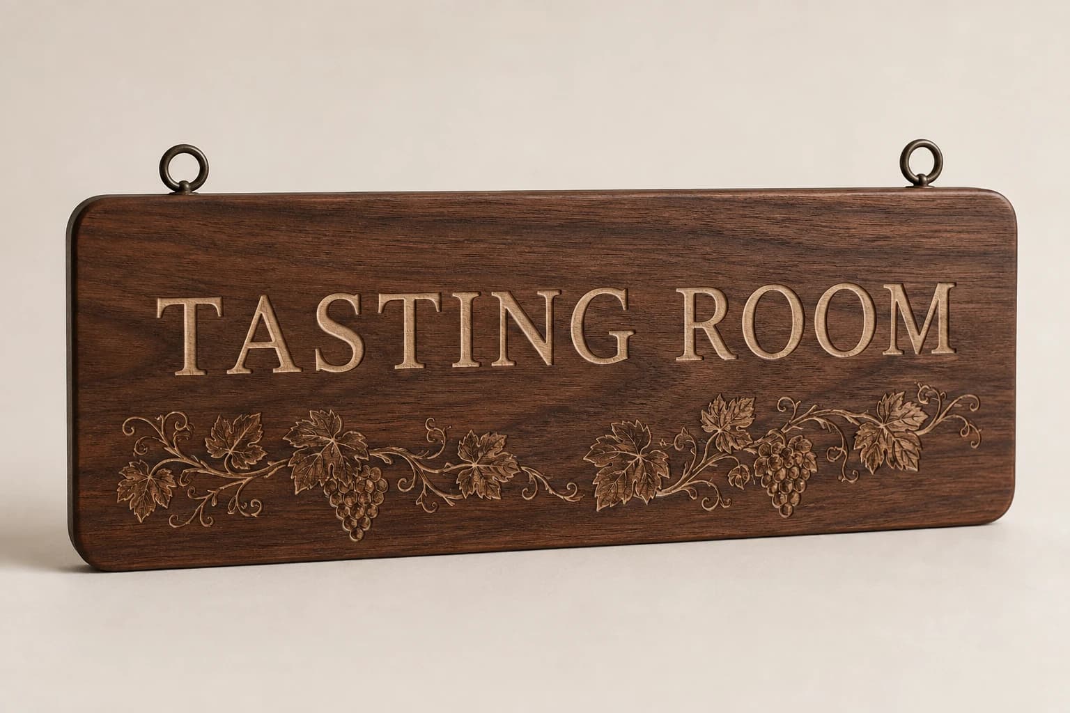 Engraved walnut tasting-room sign with a fine grapevine detail.